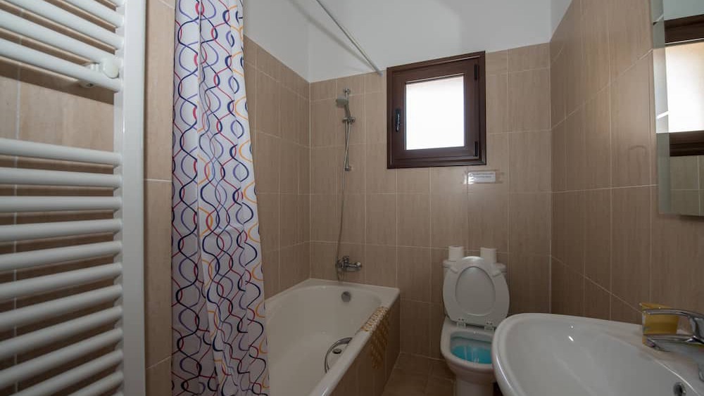 A family bathroom with bathtub and shower