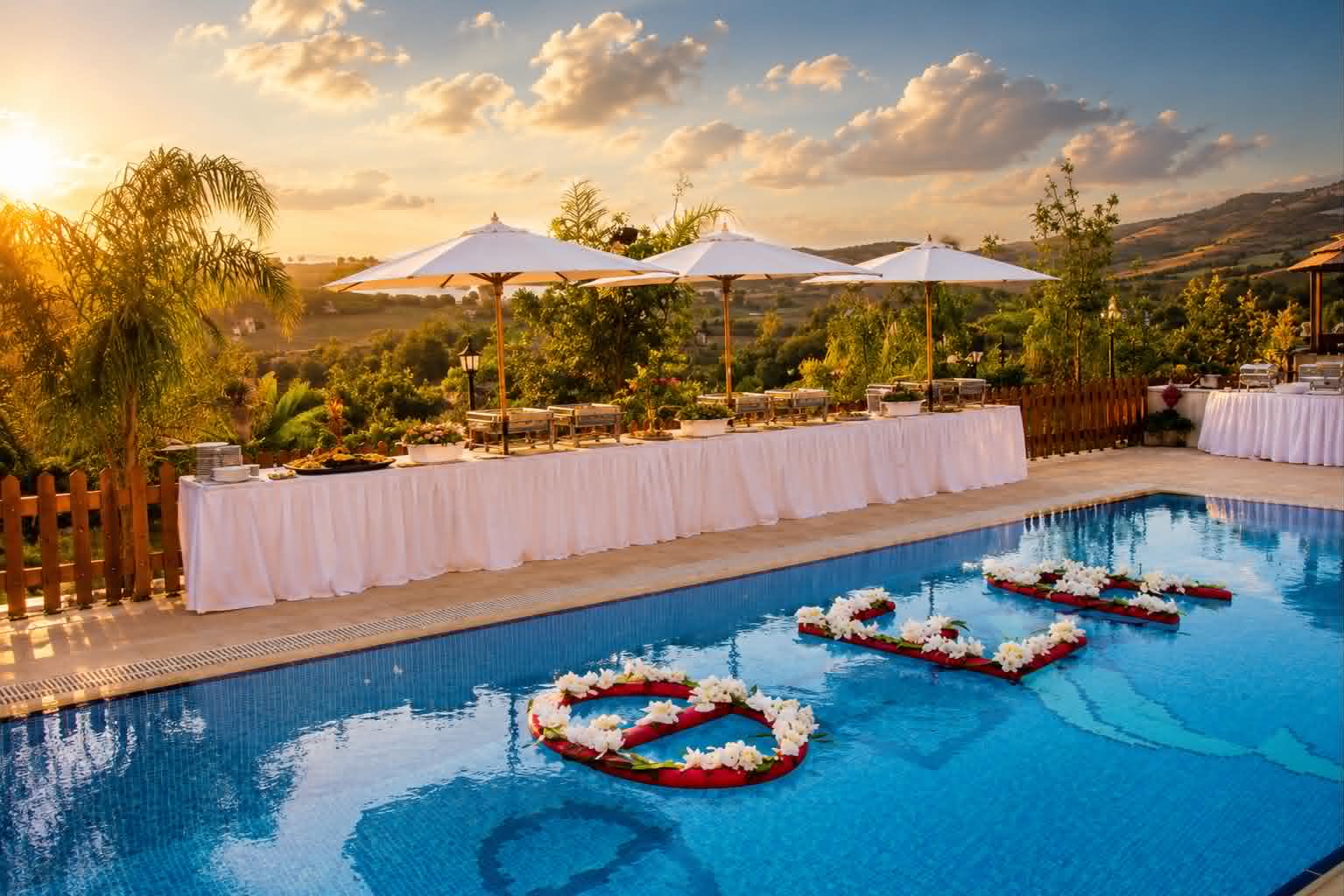 The covered terrace set with a long dining table, ready for a gathering